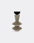 Decorative stone and carbon steel sculpture with a textured design on a white background