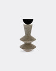 Decorative stone and carbon steel sculpture with a textured design on a white background