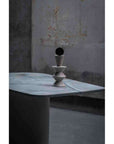 Decorative sculpture on a marble surface with a textured wall background