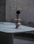 Decorative sculpture on a marble surface with a textured wall background