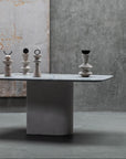 Table with soap stone sculptures against a textured wall
