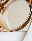 Gold decorative item on a white surface