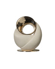 Decorative sculpture with gold and white design on a white background