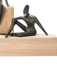 Abstract sculpture on a wooden block with a white background
