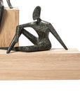 Abstract sculpture on a wooden block with a white background