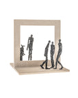 Decorative sculpture of people made in bronze and stone on a white background.
