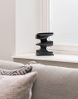Decorative metal sculpture on a windowsill with a neutral color palette
