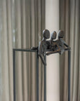 Decorative sculpture of three figures on a stand against a neutral background called Let's Talk by Gardeco