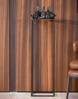 Decorative sculpture from Gardeco called Lets Talk on a stand against a wooden panelled wall with a chair partially visible.