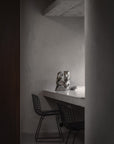 Modern interior with a desk and chairs in a minimalistic setting and the Shifting Perspectives limited edition bronze sculpture from Gardeco