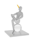 Abstract sculpture of a figure on a sphere with a yellow element on a white background