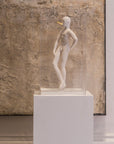 The Snob ceramic sculputre on a pedestal against a textured wall