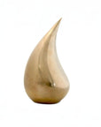 Gold teardrop-shaped decorative object on a white background from Gardeco at Spacio store in Mumbai