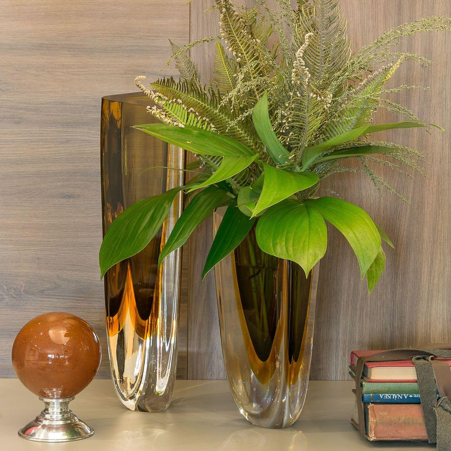 A contemporary Gardeco plant displayed in a Gardeco Glass Vase Triangle 3 Fume Amber with sleek triangular design.