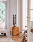 Wooden table with a decorative sculpture in a modern living room.