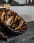 Detailed angled view of Gardeco Medium Bronze Luxury Decorative Tableware Bowl, emphasising its reflective bronze interior, artistic design, and luxury decorative appeal, available at Spacio India retail stores and online.