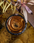 Top view of Gardeco Medium Bronze Luxury Decorative Tableware Bowl on a stylish table setting, showcasing the bowl’s reflective bronze surface and exquisite glass craftsmanship, available at Spacio India retail stores and online.
