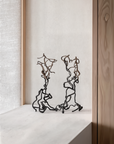 Pair of Gardeco To Return limited edition bronze sculptures styled on a ledge, luxury home art pieces available at Spacio India retail stores.