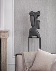 Gardeco Sol sculpture placed on black metal stand beside a contemporary sofa, ideal for adding bronze art to modern Indian luxury homes.