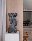 Sculptural decor by Gardeco Belgium styled against warm wood panel and neutral backdrop, available at Spacio India for luxury collectors.