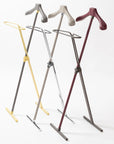 Set of four coat hangers on stands in different colors on a white background