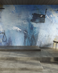 A bathroom with a blue wall adorned with Glamfusion Spilia, promoting a sense of wellness and tranquility in interior spaces. (Brand: Glamora)