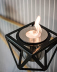 Modern black table top bioethano fireplace with against a neutral background