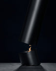 Black fire pit with flames on a dark background