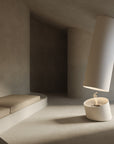 Modern white bioethanol fireplace on a textured surface with a minimalistic background