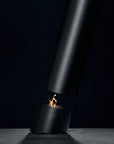Black fire pit with flames on a dark background