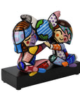 Colorful figurine on a black base against a white background