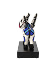 Back view of Colorful cow figurine on a black base against a white background