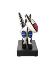 Colorful zebra figurine on a black base against a white background