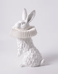 A Haoshi Rabbit Stand Lamp with a hat on its head shines as an LED light, creating a warm atmosphere.