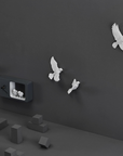 Tilted angle of Haoshi Sparrow Clock in Dark Gray color on a dark grey wall with small grey boxes available at Spacio india for modern and luxury interiors from our Timepieces and clocks collection.