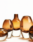 Henry Dean amber-toned glass vases in various sizes, handblown in Belgium and available at Spacio India for upscale interior styling.