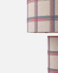 Close-up of a plaid fabric lampshade in beige with red and blue stripes, shown against a plain white background.