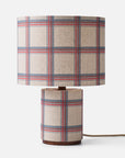 A checkered pattern fabric table lamp on a white background