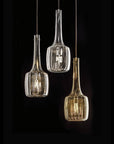 Three glass pendant lights hanging against a black background