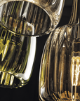 Close-up of a glass light fixture with a dark background