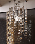 Modern chandelier hanging in a room with decorative walls