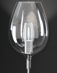Clear glass table lamp against a dark background