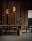 Stylish dining room featuring the Italamp Borealis Suspension light, crafted in Italy, showcasing contemporary design with amber glass and fluid metal structure, available at Spacio India.