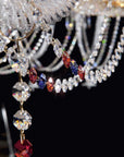 Close-up of Italamp Dogma chandelier arm detail with red, blue, and clear crystal pendants, highlighting luxury lighting by Italamp at Spacio India.