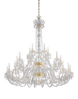 Large Italamp Dogma chandelier suspended from gold chain, highlighting its majestic scale and refined Italian design, featured at Spacio India.