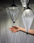 Hand interacting with the crystal diffuser of the Italamp Donna Suspension Lamp, highlighting the brilliance and material quality – Spacio India