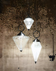 Warmly lit Italamp Donna Suspension Lamp with black accents, creating a dramatic glow against a textured wall – premium lighting at Spacio India