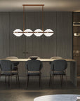 Italamp Ellepi chandelier in bronze metal with satin glass diffusers, suspended over a dining table – available at Spacio India for modern interiors.