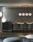 Italamp Ellepi chandelier and floor lamp in a contemporary dining setting, featuring satin glass and bronze finish – shop the Ellepi collection at Spacio India.