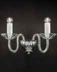Italamp Evoque Wall Lamp in hand-carved clear crystal with twin arms and candle-style bulbs, available at Spacio India for luxury wall lighting.